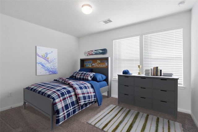 carpeted bedroom featuring multiple windows