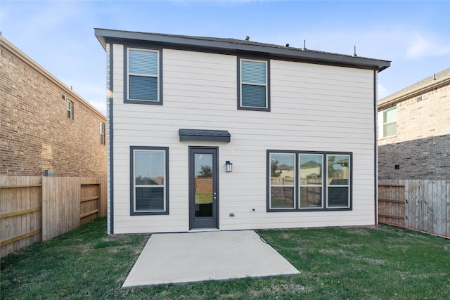 rear view of property featuring a patio and a yard