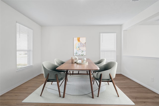 dining space featuring hardwood / wood-style floors and plenty of natural light