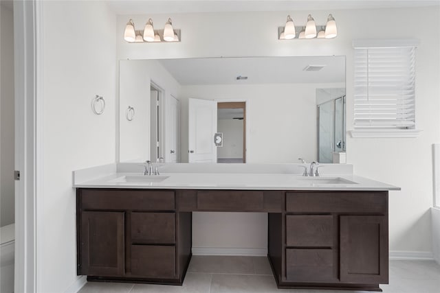 bathroom featuring walk in shower, tile patterned flooring, and vanity