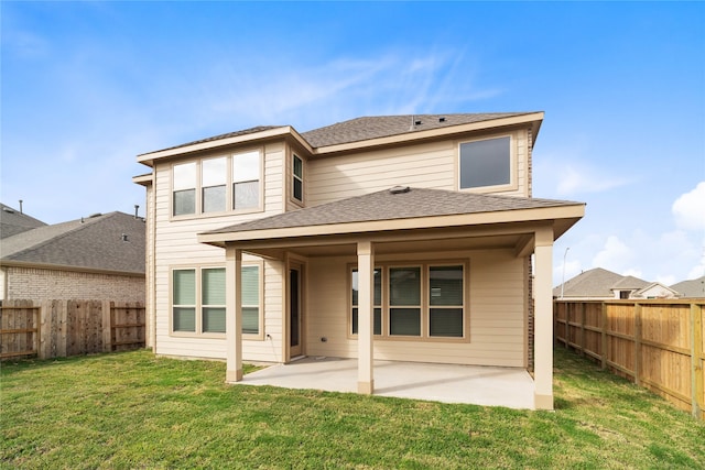 back of property featuring a lawn and a patio