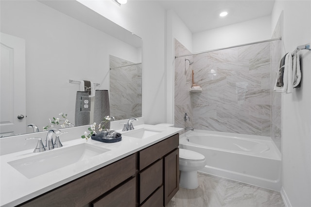 full bathroom featuring tiled shower / bath, toilet, and vanity