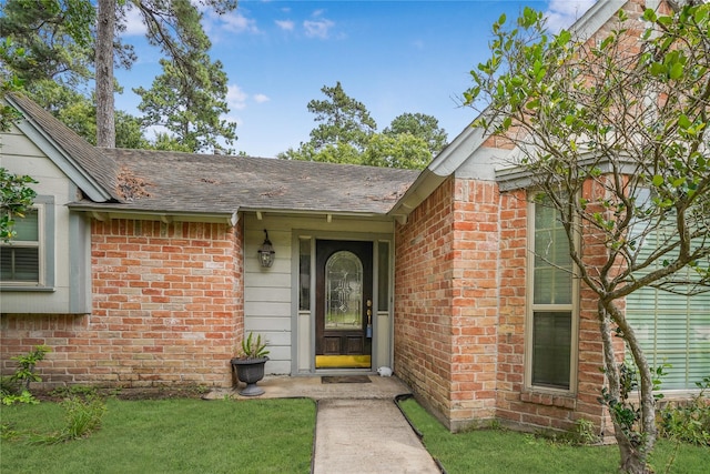 property entrance with a lawn