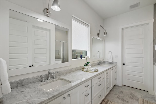 bathroom with dual bowl vanity and tile flooring