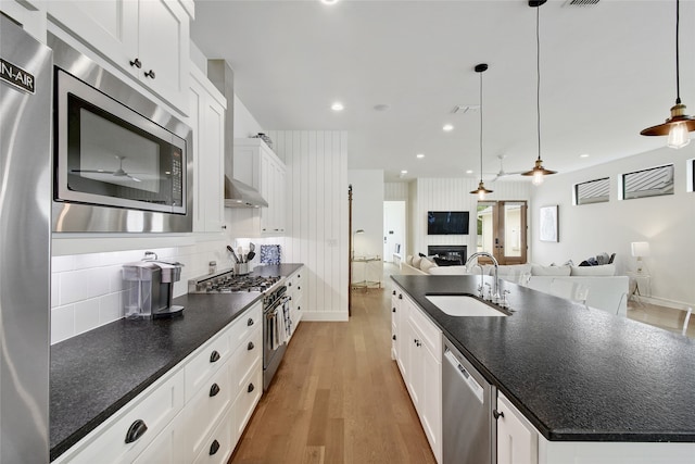 kitchen featuring ceiling fan, light hardwood / wood-style flooring, sink, white cabinets, and appliances with stainless steel finishes