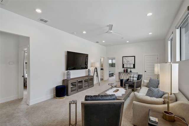 living room with ceiling fan and light carpet