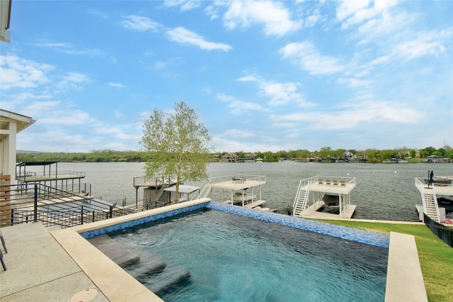 view of swimming pool with a water view and a dock