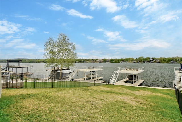 dock area featuring a water view and a lawn