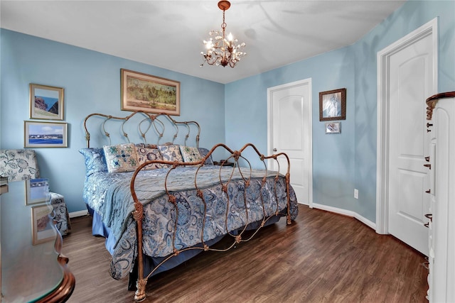 bedroom with a chandelier and dark hardwood / wood-style floors