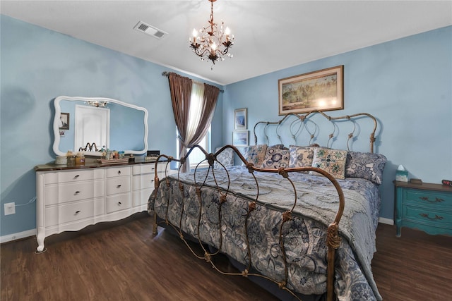 bedroom featuring a notable chandelier and dark hardwood / wood-style floors