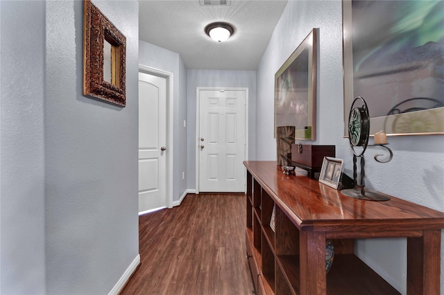 corridor featuring dark hardwood / wood-style flooring