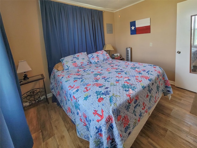 bedroom featuring hardwood / wood-style flooring and ornamental molding