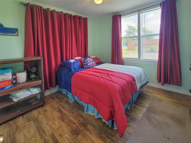 bedroom with ceiling fan and dark hardwood / wood-style floors