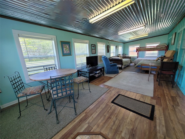 interior space with plenty of natural light, hardwood / wood-style floors, and vaulted ceiling