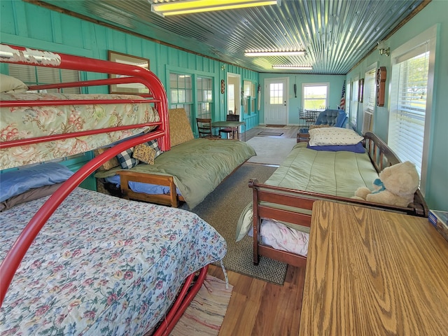 bedroom featuring hardwood / wood-style flooring, vaulted ceiling, and ornamental molding