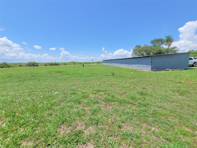 view of yard with a rural view