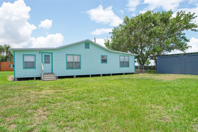 back of house with a yard