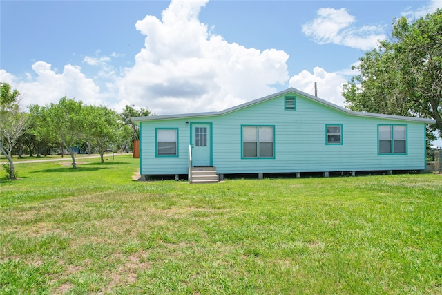 back of property featuring a lawn