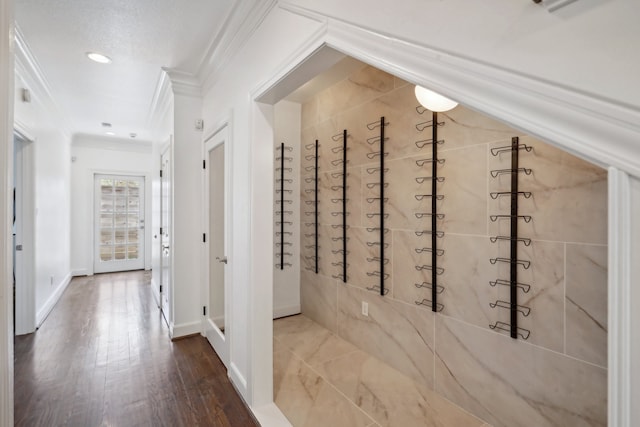 hallway with wood-type flooring and crown molding