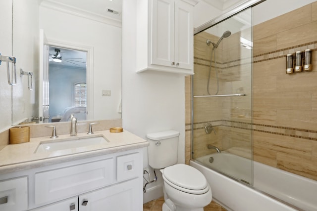 full bathroom featuring enclosed tub / shower combo, toilet, vanity, ceiling fan, and ornamental molding