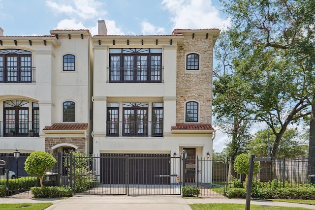 mediterranean / spanish house with a garage