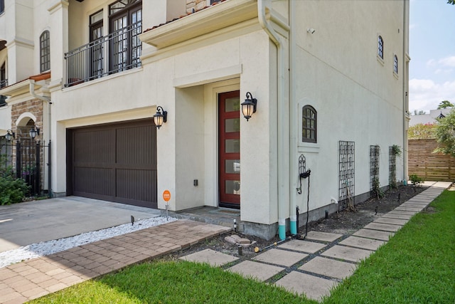 exterior space with a garage and a balcony