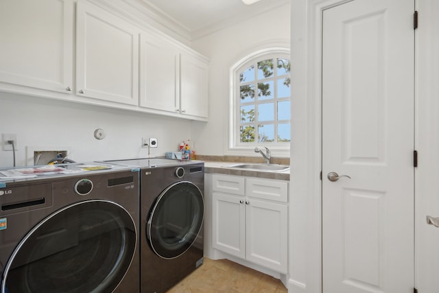 washroom featuring sink, separate washer and dryer, cabinets, and ornamental molding