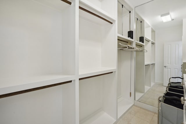 walk in closet featuring light tile patterned floors