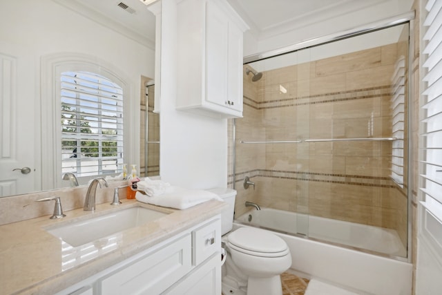 full bathroom with vanity, combined bath / shower with glass door, crown molding, and toilet