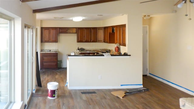 kitchen featuring ceiling fan, lofted ceiling with beams, and dark hardwood / wood-style flooring