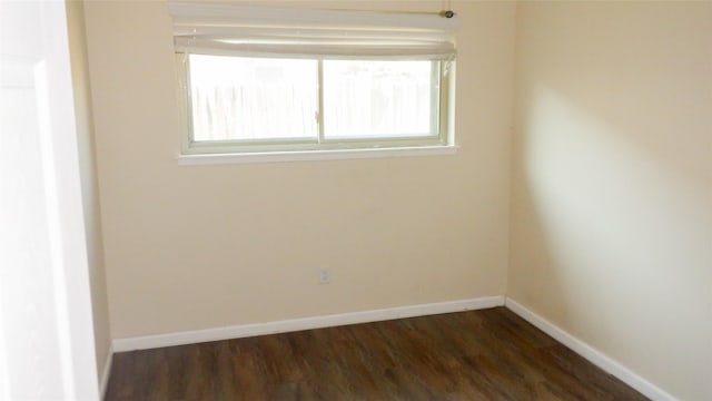 spare room featuring dark wood-type flooring