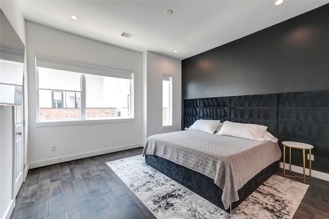 bedroom with dark wood-type flooring