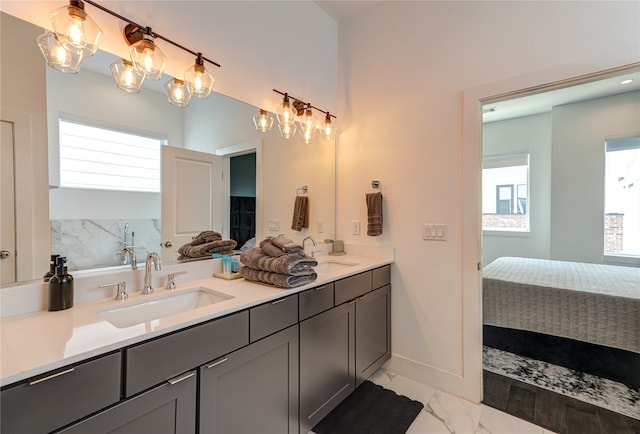 bathroom with dual vanity, plenty of natural light, and tile floors