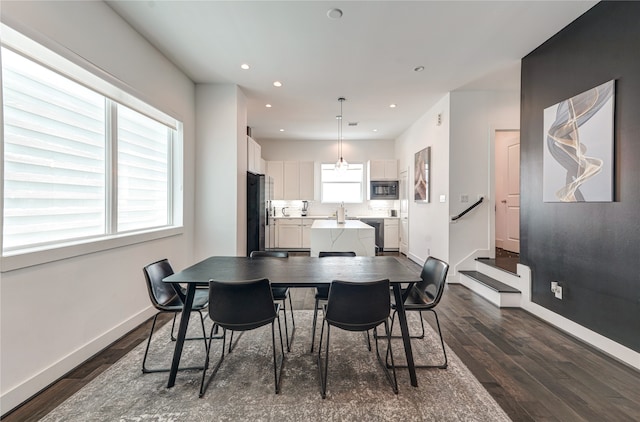 dining space with dark hardwood / wood-style floors