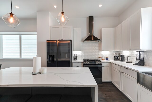 kitchen featuring wall chimney range hood, dark hardwood / wood-style floors, backsplash, and black appliances