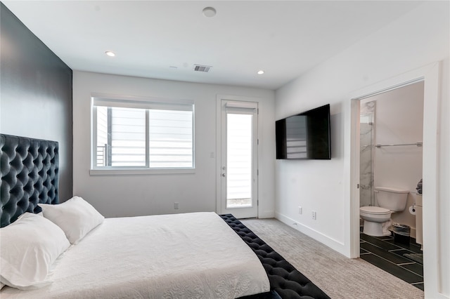 tiled bedroom with connected bathroom and multiple windows