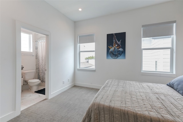 carpeted bedroom with ensuite bath