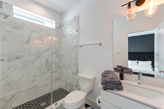 bathroom featuring a shower with door, vanity, and toilet