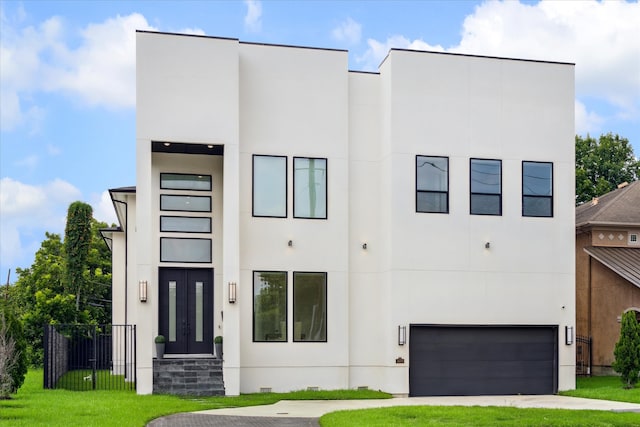 contemporary home with a garage and a front lawn