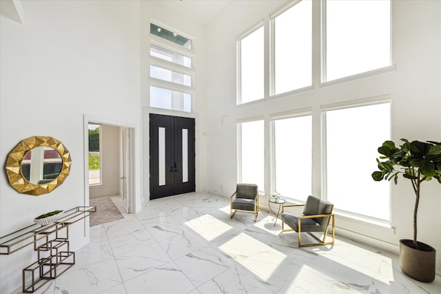 tiled entrance foyer with a high ceiling