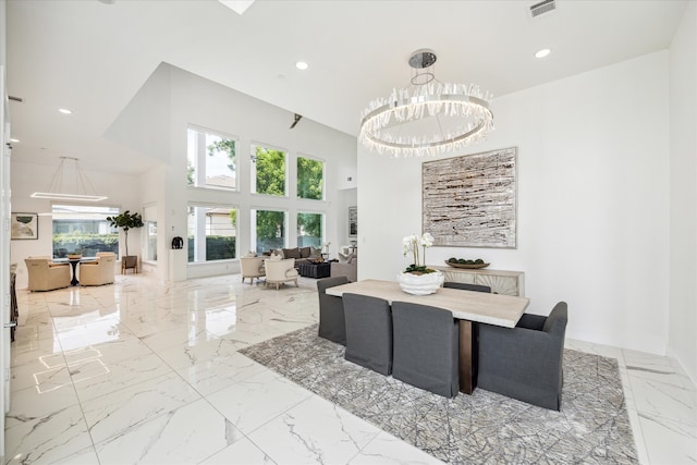 dining room with a chandelier and light tile floors