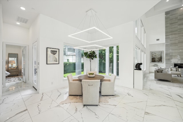 tiled dining area with a notable chandelier and tile walls