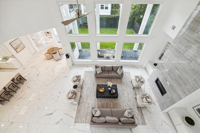 living room with tile flooring and a towering ceiling