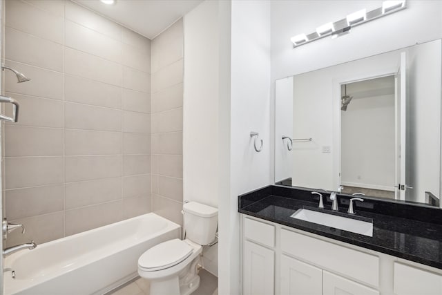 full bathroom with tile floors, tiled shower / bath combo, vanity, and toilet