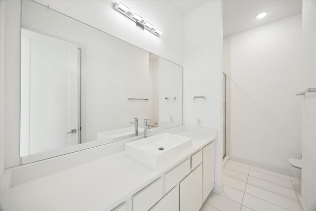 bathroom featuring toilet, tile floors, and large vanity