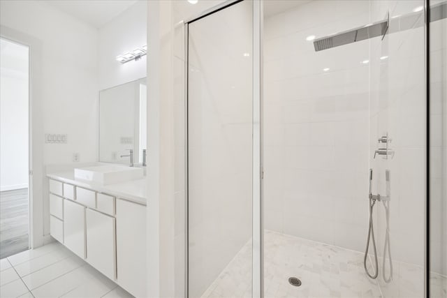 bathroom with walk in shower, oversized vanity, and tile floors