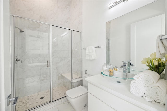 bathroom featuring tile floors, a shower with door, toilet, and vanity