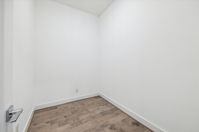 unfurnished room with hardwood / wood-style flooring