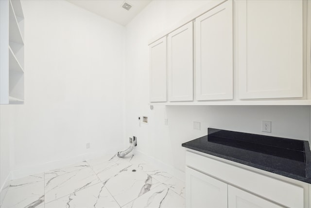 washroom with hookup for a washing machine, hookup for an electric dryer, cabinets, and light tile floors