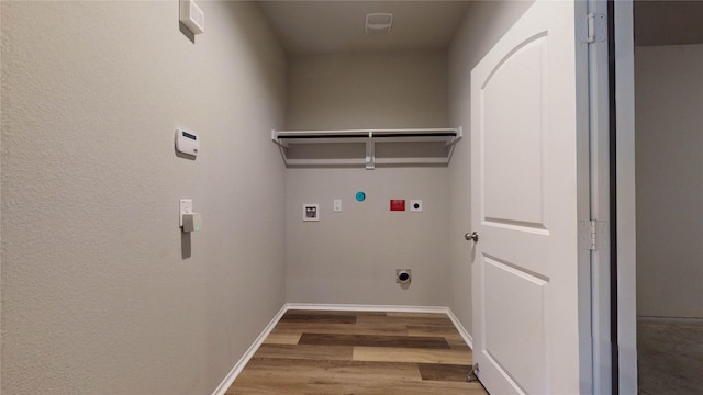 clothes washing area featuring hardwood / wood-style floors, hookup for a washing machine, and electric dryer hookup